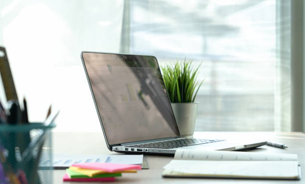 istock Top view desk of work table in office with laptop computer , notebook , calculator and a cup of coffee for creative business work or marketing plan to success planning of company 961634334