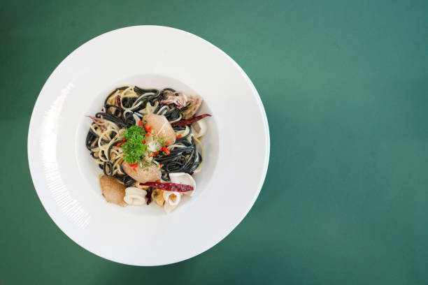 istock Black spaghetti seafood garlic fry on the table 961634368