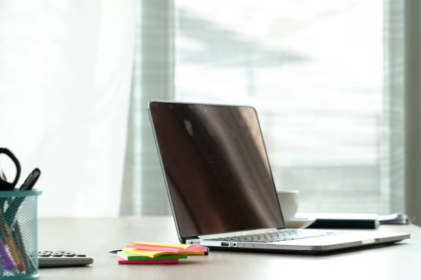 istock Top view desk of work table in office with laptop computer , notebook , calculator and a cup of coffee for creative business work or marketing plan to success planning of company 961634370