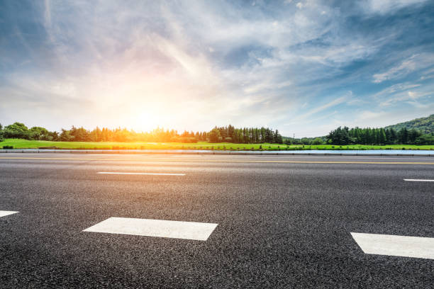 istock Asphalt road and forest with sky clouds landscape at sunset 961634390