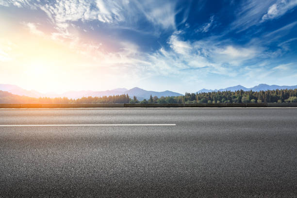 istock Asphalt road and hills with clouds landscape at sunset 961634644