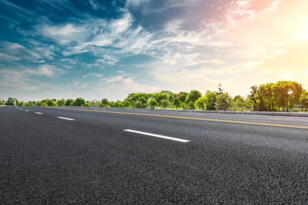 istock Empty asphalt road and woods landscape at sunset 961634744