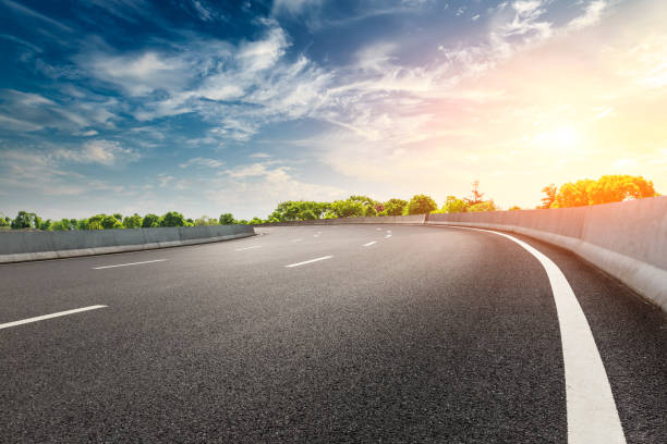 istock Empty asphalt road and woods landscape at sunset 961634816