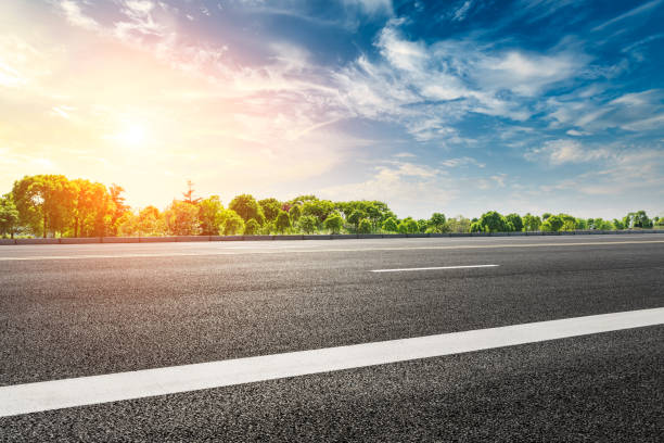 istock Empty asphalt road and woods landscape at sunset 961635028