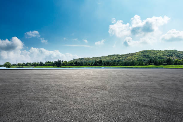 istock Asphalt square road and hills with clouds landscape 961637222