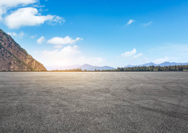 istock Asphalt square road and hills with clouds landscape 961637308