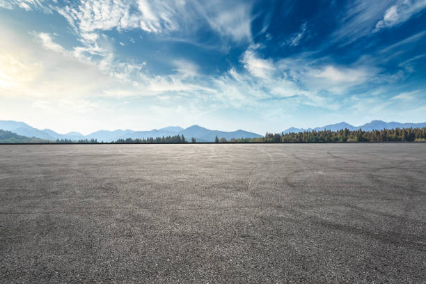 istock Asphalt square road and hills with clouds landscape at sunset 961637374