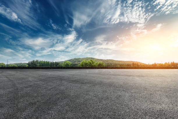 istock Asphalt square road and hills with clouds landscape at sunset 961637414