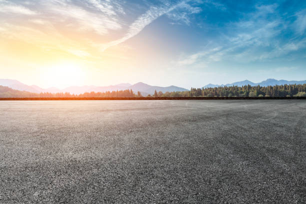 istock Asphalt square road and hills with clouds landscape at sunset 961637498