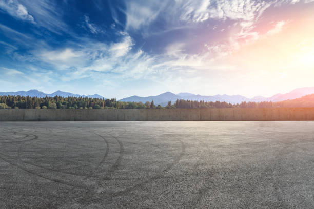 istock Asphalt square road and hills with clouds landscape at sunset 961637534