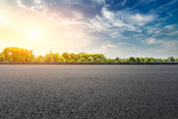 istock asphalt road and woods landscape at sunset 961637590