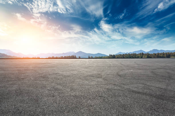 istock Asphalt square road and hills with clouds landscape at sunset 961637620
