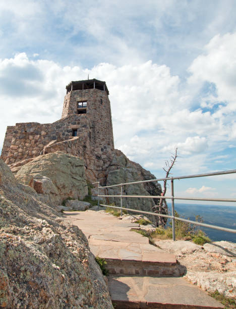 istock Black Elk Peak [formerly known as Harney Peak] Fire Lookout Tower under cumulus cloudscape in Custer State Park in the Black Hills of South Dakota United States 961638408