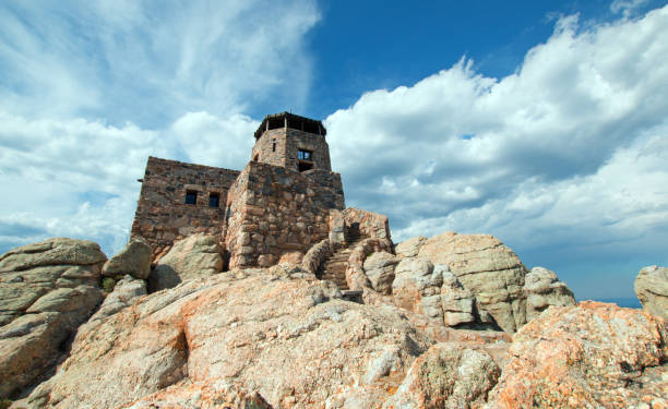 istock Black Elk Peak [formerly known as Harney Peak] Fire Lookout Tower under cumulus cloudscape in Custer State Park in the Black Hills of South Dakota United States 961638990