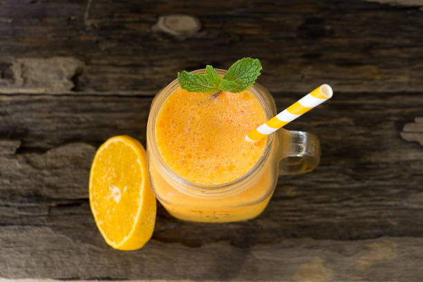 istock Orange smoothies fruit yogurt and Orange fruit on an old wood background. 961641118