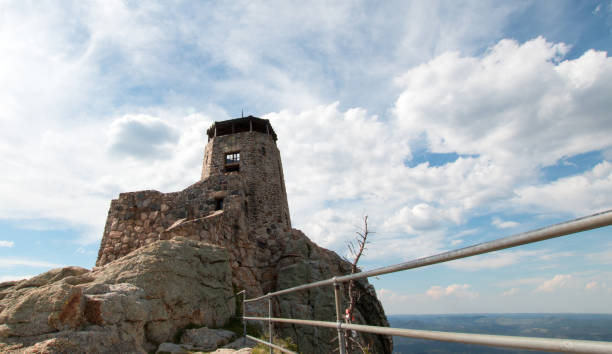 istock Black Elk Peak [formerly known as Harney Peak] Fire Lookout Tower under cumulus cloudscape in Custer State Park in the Black Hills of South Dakota United States 961641876