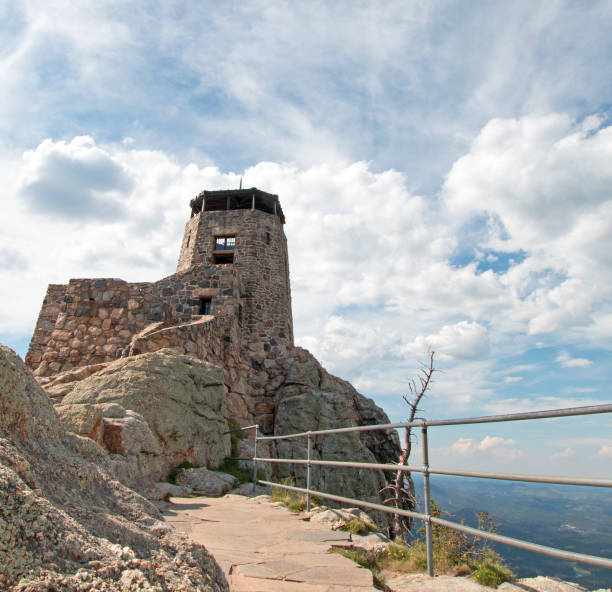 istock Black Elk Peak [formerly known as Harney Peak] Fire Lookout Tower under cumulus cloudscape in Custer State Park in the Black Hills of South Dakota United States 961642416