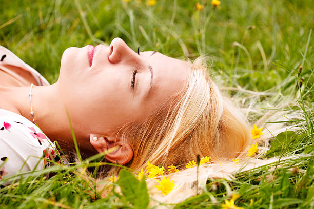 istock girl lying on green grass 96164249