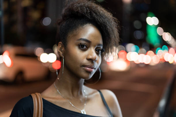 Afro young woman portrait in the city at night