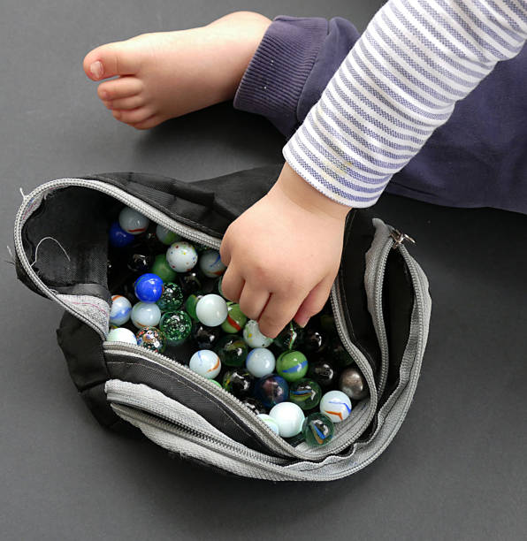 istock A baby playing with glass marbles, 961644966