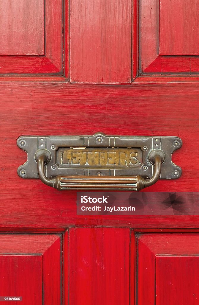 Bright red patina door with old metal "letters" slot.  Mail Slot Stock Photo
