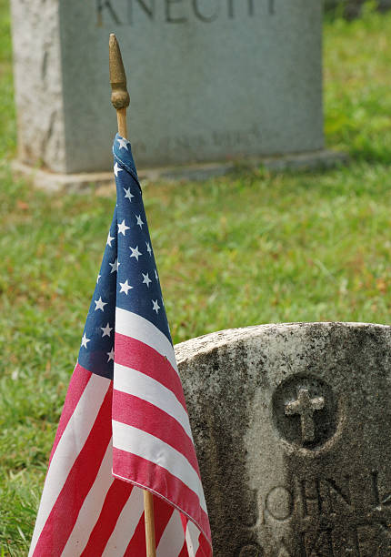 istock U.S. Flag next to headstone of fallen WWI soldier. 96164603