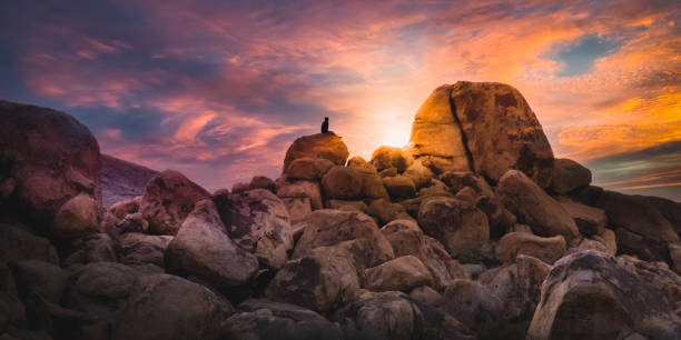 Sitting and Watching the Sunset Blaze over High Desert Boulders