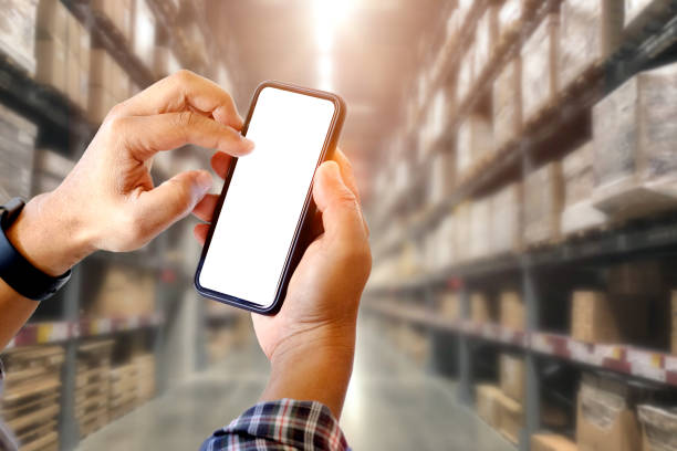 istock Cropped shot of man using smartphone in distribution warehouse. 961648486