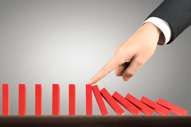 istock Hand Stopping domino concept 961663844