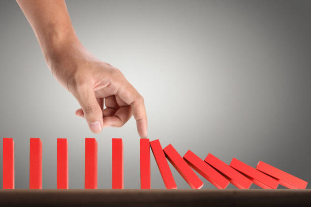 istock Hand Stopping domino concept 961663848