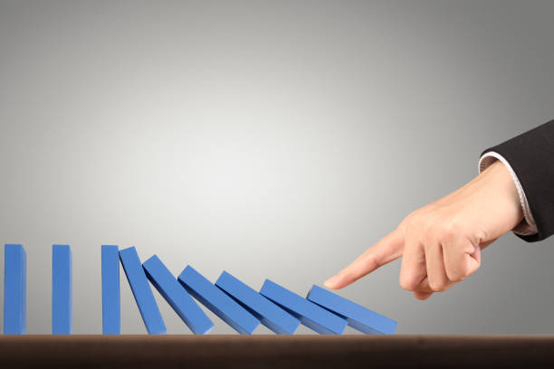 istock Hand Stopping domino concept 961663880