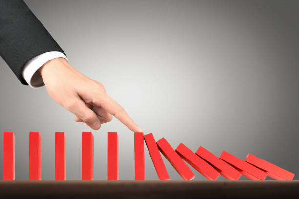 istock Hand Stopping domino concept 961663888