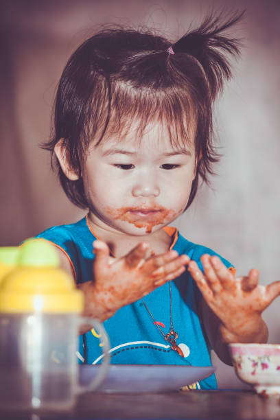 istock Child eating with a stained face. Do it yourself concept. Vintage tone. 961671706