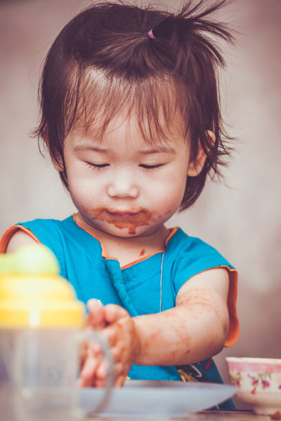 istock Child eating with a stained face. Do it yourself concept. Vintage tone. 961671834