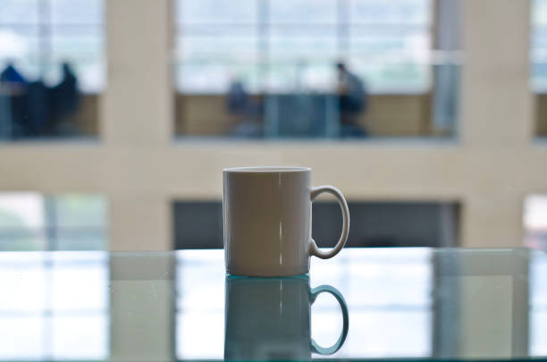 istock A blank white mug on the glass table 961672742