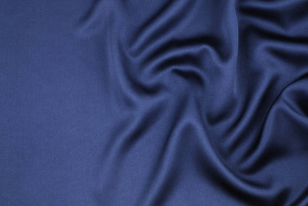 Wavy blue satin  bed sheets stock pictures, royalty-free photos & images