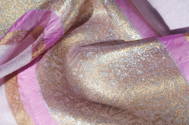 istock Texture, background, pattern. Combined silk white fabric and gold and silver damask fabric, pink ribbons 961677176