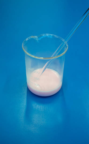 istock Soap making process in laboratory. Coloring and stirring with glass stirrer. 961678684