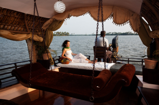 woman lying enjoying houseboat tour e backwaters in Kerala state india