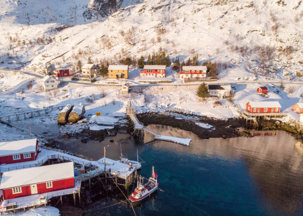 Aerial view red hut fishing village on coastline in winter Aerial view red hut fishing village on coastline in winter season reine lofoten stock pictures, royalty-free photos & images