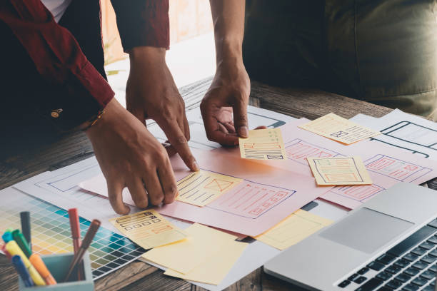 istock Close up of creative managers crew working with new startup project for web design. Contemporary notebook on wood table 961695070