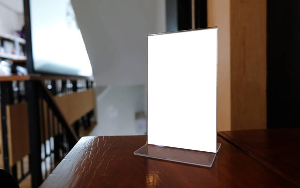 istock Mock up Menu frame standing on wood table in Bar restaurant cafe. space for text. 961695714