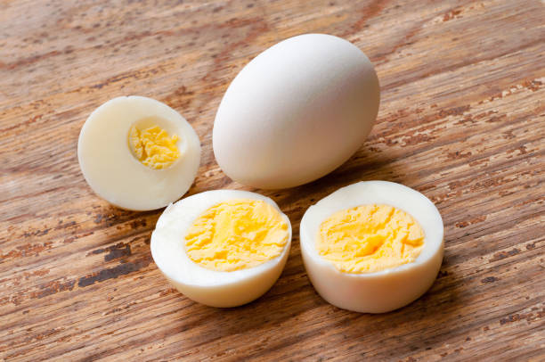 istock Closeup unpeeled boiled egg and half eggs on white background , food menu concept 961697156