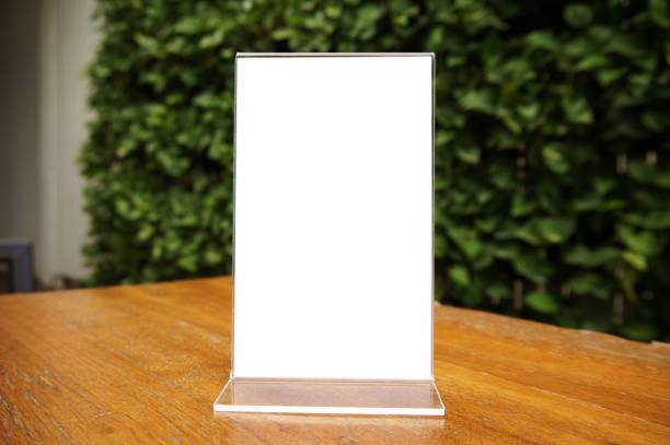 istock Mock up Menu frame standing on wood table in Bar restaurant cafe. space for text 961699702