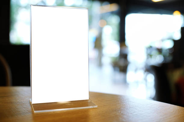 istock Mock up Menu frame standing on wood table in Bar restaurant cafe. space for text 961700448