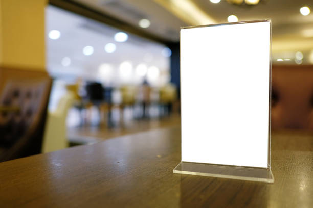istock Mock up Menu frame standing on wood table in Bar restaurant cafe. space for text 961701286