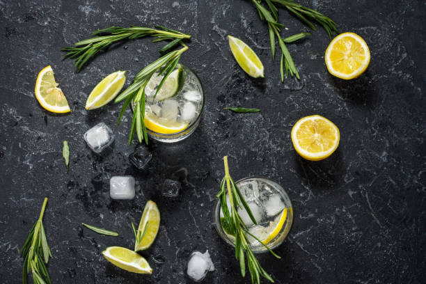 istock Alcoholic drink gin tonic cocktail with lemon, rosemary and ice on stone table 961704328