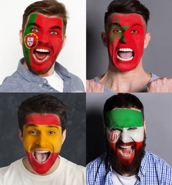 istock Emotional soccer fans with painted flags on faces 961704606