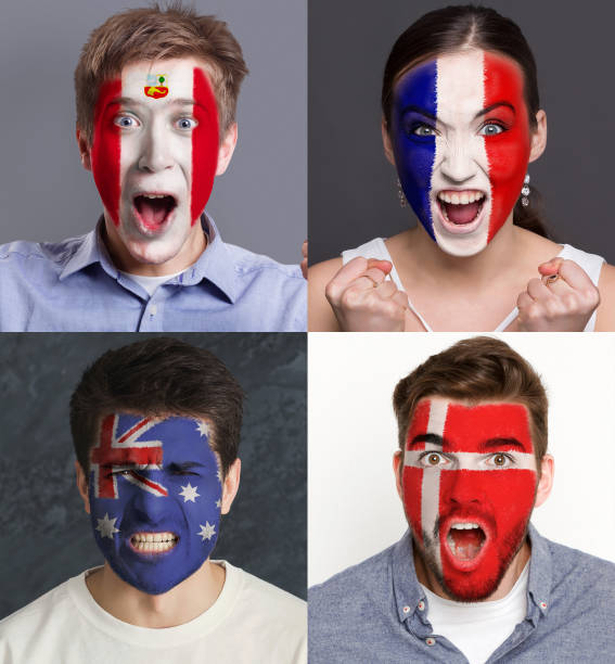 istock Emotional soccer fans with painted flags on faces 961704754