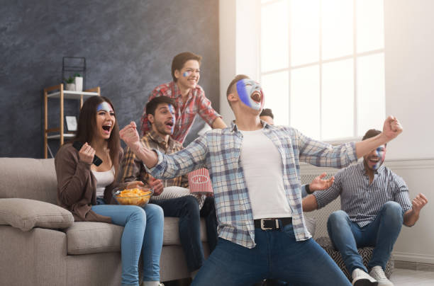 istock Happy sport fans with colored faces at home 961705886